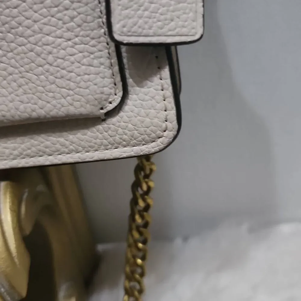 Coach Tabby Mini Chain Clutch in Chalk pebbled leather with gold-tone upgraded c